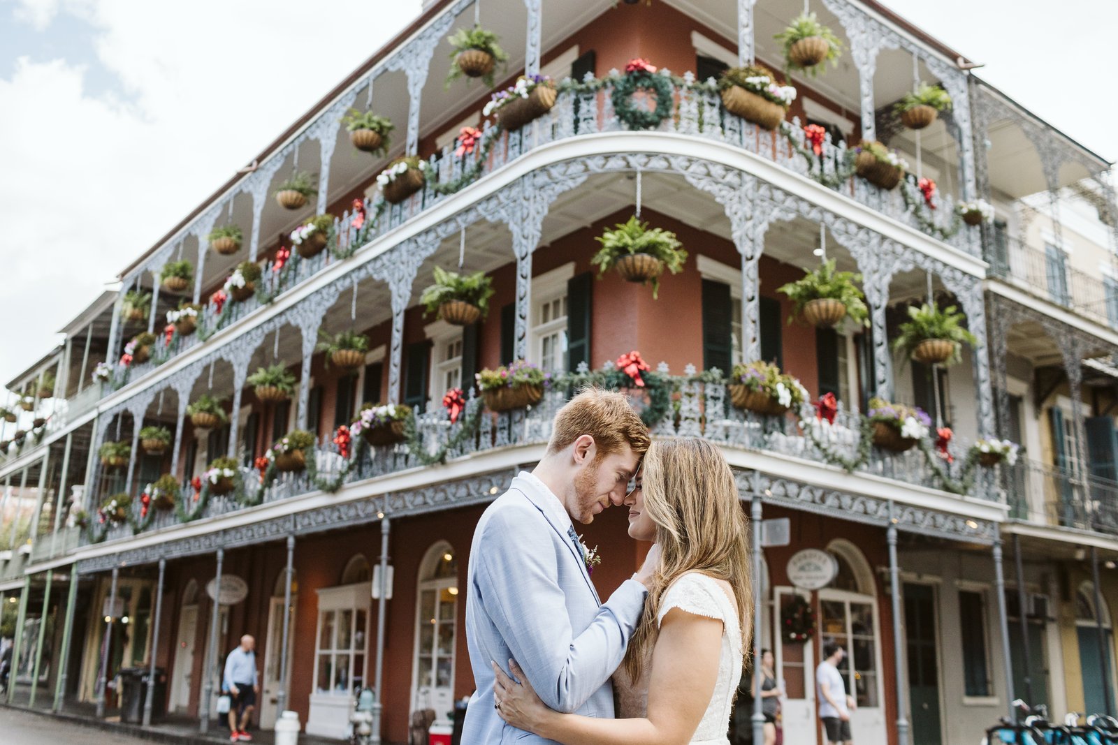 Couple sharing intimate vow renewal moment outdoors.