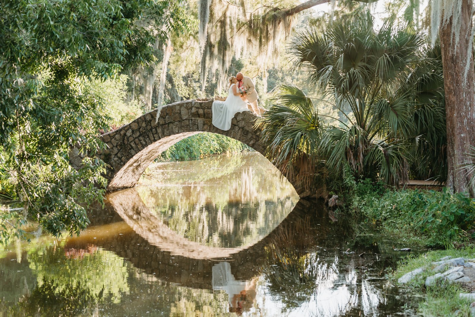 Couple kissing on a bridge after vow renewal in New Orleans